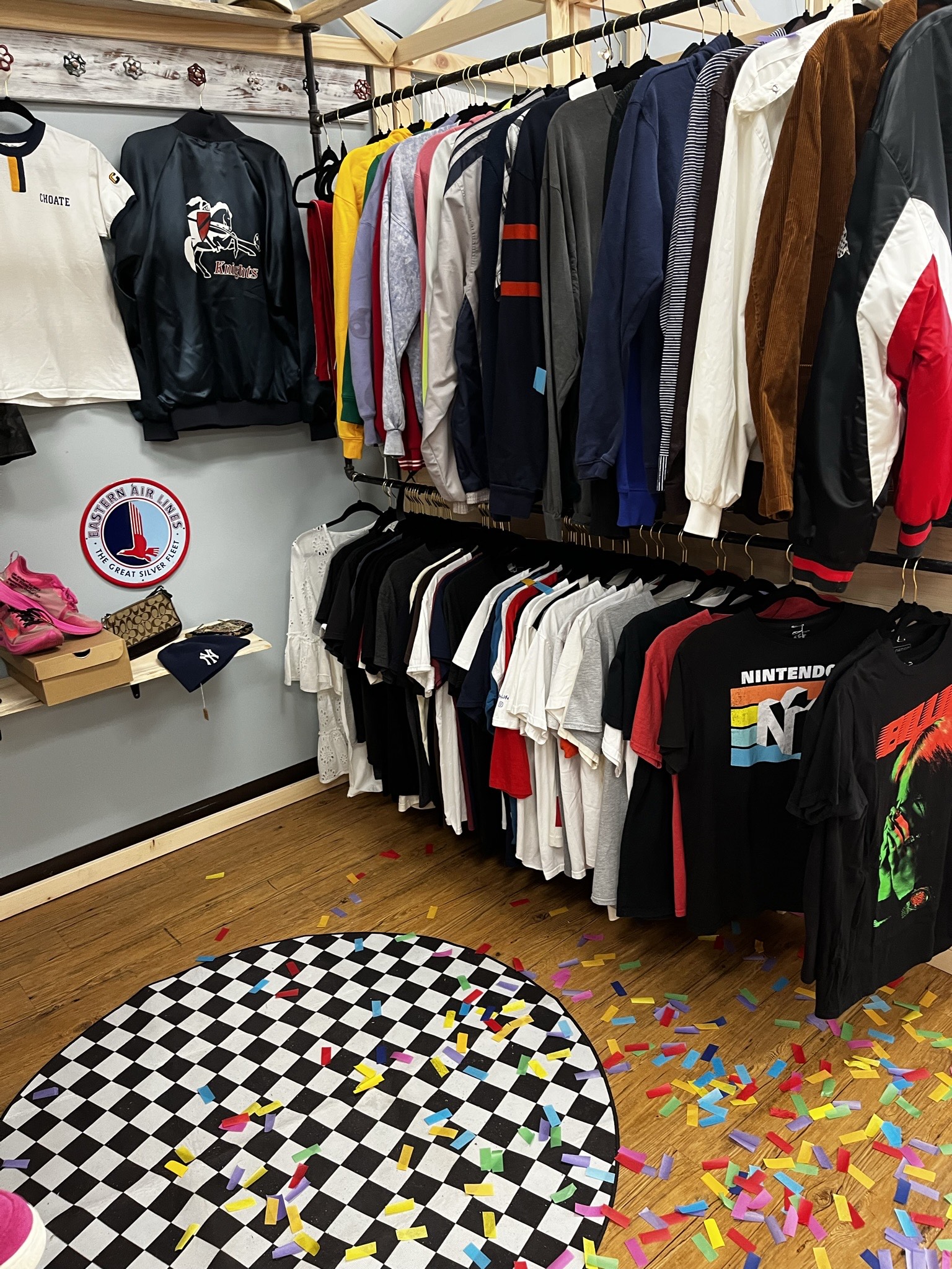 two clothing racks with Vintage sweatshirts and tees